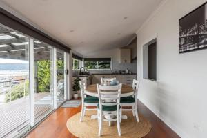 a kitchen and dining room with a table and chairs at View Point: Ocean Views & Near CBD in Burnie