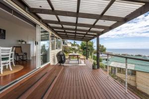 a deck with a view of the ocean from a house at View Point: Ocean Views & Near CBD in Burnie