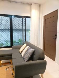 a living room with a couch and a large window at JD&S Apartments Unit 2 in Iligan City