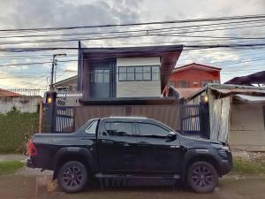 a black truck parked in front of a house at JD&S Apartments Unit 2 in Iligan City