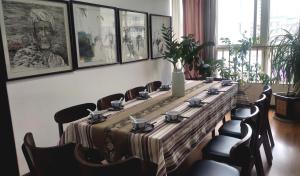 a long table in a room with chairs and posters at Annie Apartment 2505 in Kunming