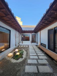 a courtyard of a house with a pathway at Han Yul Jae - Hanok in Chuncheon