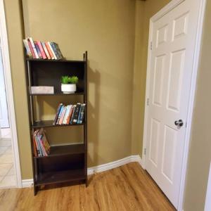 a room with a book shelf filled with books at Private suite with AC Near Cultus Lake and Heritage Park in Chilliwack