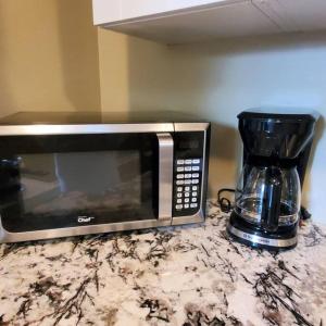 a microwave sitting on a counter next to a coffee maker at Private suite with AC Near Cultus Lake and Heritage Park in Chilliwack