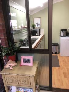 a kitchen with a sink and a mirror at Tamborine Mountain Lodge in Mount Tamborine