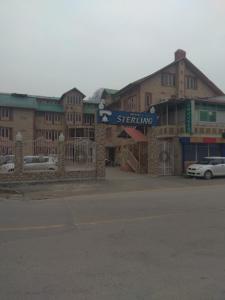 a building with a sign on the side of a street at Hotel Sterling , Srinagar in Srinagar