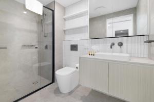 a bathroom with a toilet and a sink and a shower at The Residences at The Peninsula in Gold Coast +91 photos