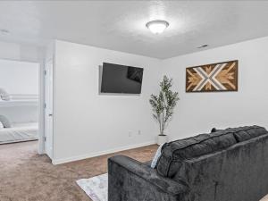 a living room with a couch and a tv at Heber Apartment Hideaway in Heber City
