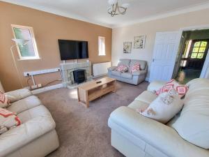 a living room with two couches and a fireplace at City SuperHost - Peaceful Home in Salford in Manchester