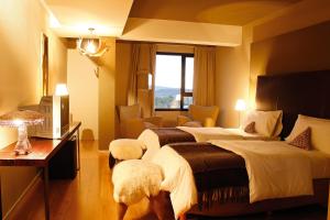 um quarto de hotel com duas camas e uma janela em Esplendor by Wyndham El Calafate em El Calafate