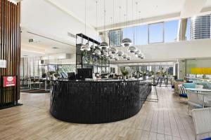 a lobby with a bar in the middle of a building at Ocean View 2-Bed Studio In the Heart of Surfers in Gold Coast
