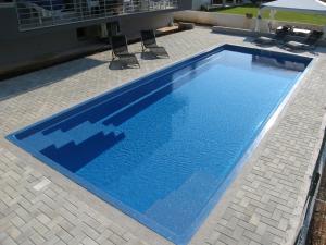 a large blue swimming pool sitting next to a building at House Barbara in Banjole