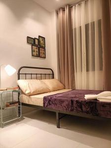 a bedroom with two beds and a window at JD&S Apartments Unit 4 in Iligan City