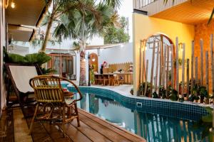 a house with a swimming pool and a patio at Homestay Bingo LaGi 2 in Tân Tạo