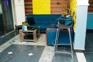 a blue couch and a table and a chair at FORTUNE PEARL HOTEL in Lagos