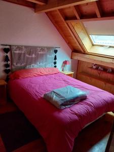 a bedroom with a red bed with a window at Marmotte 2 in Ornon