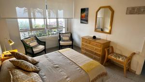 a bedroom with a bed and a dresser and a mirror at Brisas del Mar Mediterráneo in Aguadulce