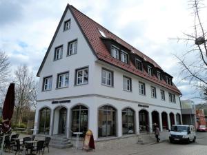 a large white building with a red roof at Holiday apartment Randersacker in Randersacker