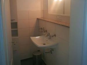 a bathroom with a white sink and a mirror at Pleasant apartment in Baden-Württemberg in Eisenbach