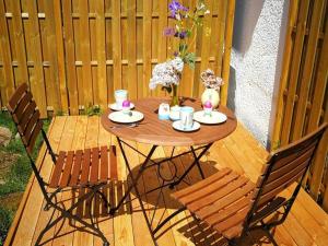 a wooden table and chairs on a wooden deck at Pleasant apartment in Baden-Württemberg in Eisenbach