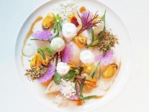 a white plate of food with flowers on it at Modern, high-quality chalet with WiFi in Wemeldinge