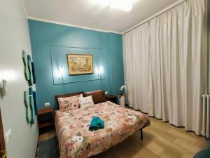 een slaapkamer met een bed met een blauwe muur bij GARDEN in Milaan