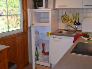 an open refrigerator in a kitchen with a sink at Cosy apartment in Userin in Userin