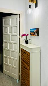 a bathroom with a sink and a door with a flower at Brisas del Mar Mediterráneo in Aguadulce