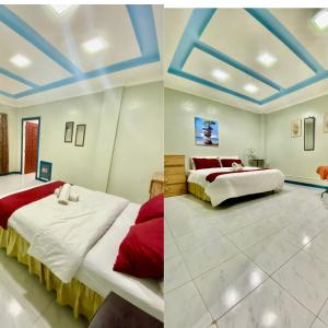 two beds in a room with blue ceilings at Panabo Furnished house-Downstairs in Panabo