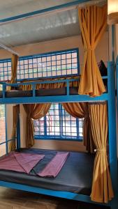 two bunk beds in a room with a window at Masawi Home in Can Tho