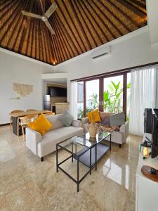 a living room with a couch and a table at Villa Venta by Maheswara in Uluwatu