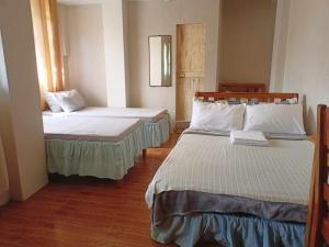 Postel nebo postele na pokoji v ubytování Pas-it Hostel Sagada