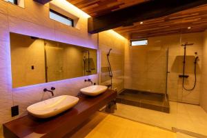 a bathroom with two sinks and a shower at 藤左ヱ門の宿 in Sudagai +18 photos