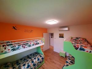 2 stapelbedden in een kamer met oranje muren bij New Bedrooms Mamma Gigetta in Noventa di Piave