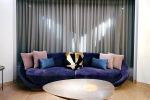 a purple couch in a living room with a table at W Chengdu in Chengdu