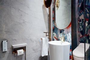 a bathroom with a white sink and a mirror at W Chengdu in Chengdu