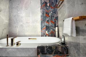 a bathroom with a sink and a bath tub at W Chengdu in Chengdu