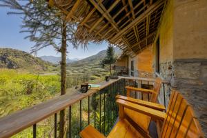 a balcony with a bench and a view at Sapaxa Spring Garden Ecolodge in Sapa