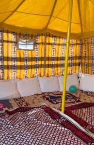 a yellow tent with a net in the middle at Dolphin Campground in Barka