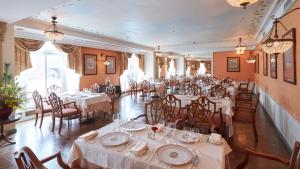a dining room with white tables and chairs at Hotel Europe Huis Ten Bosch in Sasebo +24 photos