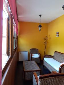 a room with chairs and a bed and a window at CASA OSO 1 in Pola de Somiedo