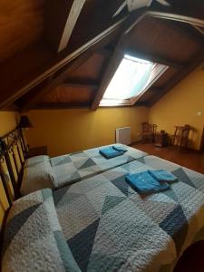 a bedroom with two beds in a attic at CASA OSO 1 in Pola de Somiedo