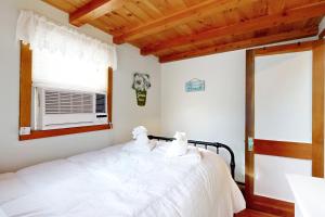 - une chambre avec un lit blanc et une fenêtre dans l'établissement Cozy Escape on the Cape, à Eastham