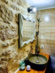 a bathroom with a sink and a stone wall at The Secret Ontas, Traditional stone house in Rethymno