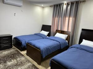 Ένα ή περισσότερα κρεβάτια σε δωμάτιο στο Amro Petra Apartment