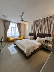 a bedroom with a large bed and a large window at WAAFI LA CORNICHE RESIDENCE in Djibouti