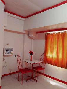 a room with a table and chairs and a window at WJV INN BACOLOD in Bacolod +22 photos