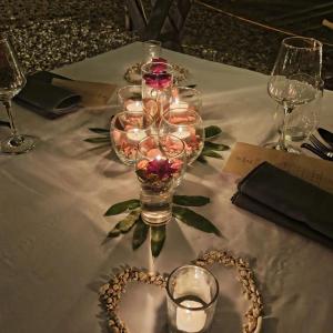 a table with wine glasses and a heart on it at Bugana Beach and Dive Resort in Manlocahoc