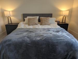 a bedroom with a large bed with two lamps at Modern, Spacious & Relaxing Home in Sparks, NV in Sparks +33 photos