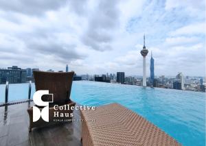 a swimming pool on the roof of a building with a city at The Platinum 2 Kuala Lumpur By Collective Haus in Kuala Lumpur